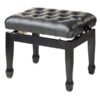 Tabouret de piano noir avec siège matelassé en cuir, style élégant et pieds en bois massif.