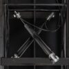 Mécanisme hydraulique croisé en métal noir, renforçant la structure et la stabilité d'un meuble moderne.