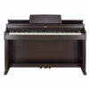 Un piano numérique Casio de couleur marron foncé, avec trois pédales en bas, est présenté sur un fond blanc.